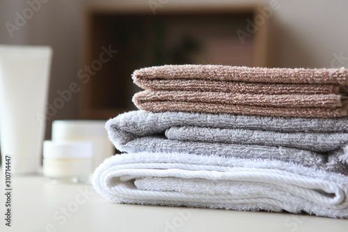 a stack of fresh towels on the table.