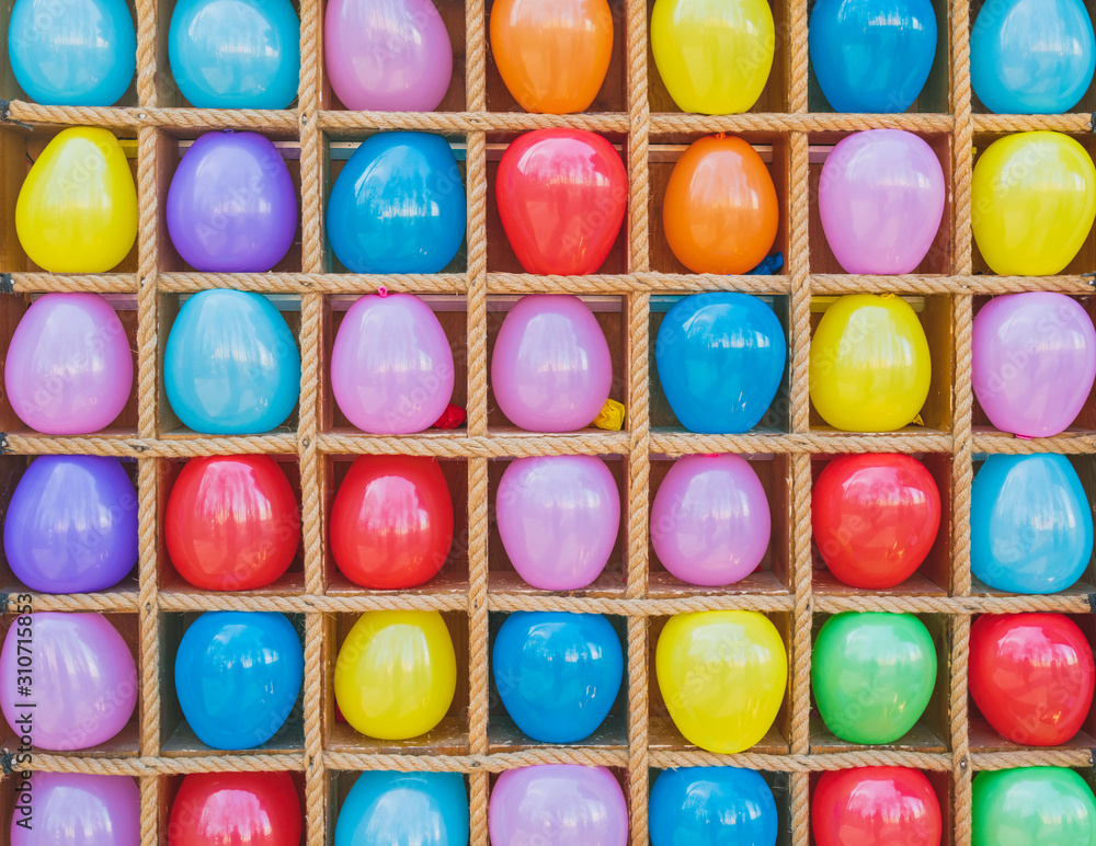 Background of multicolored real balloons in row close-up. Pattern of leisure activity.