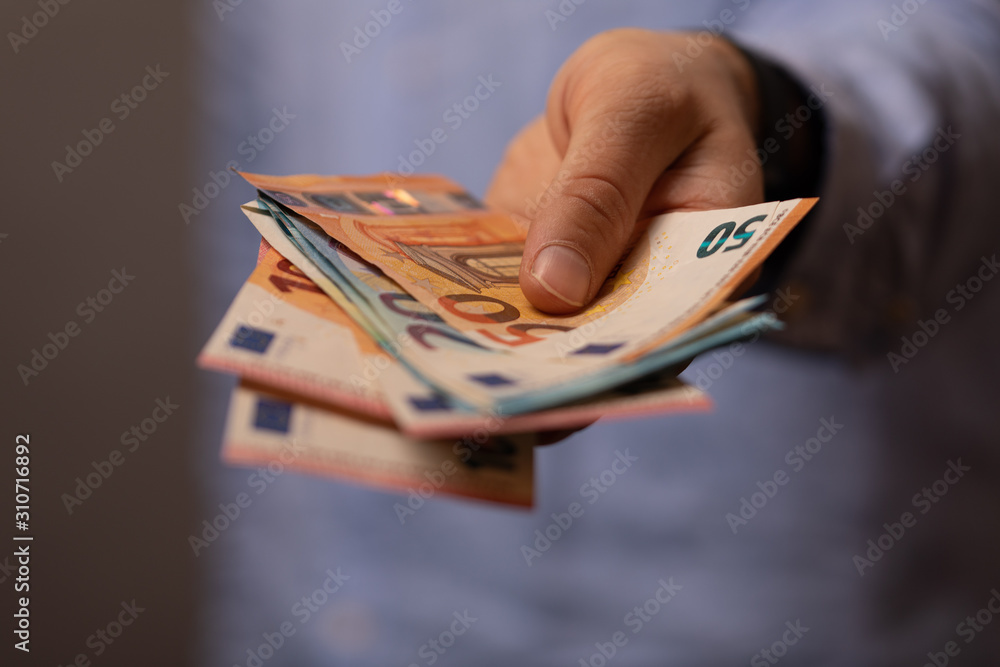 money euro in man hand - obrazy, fototapety, plakaty 