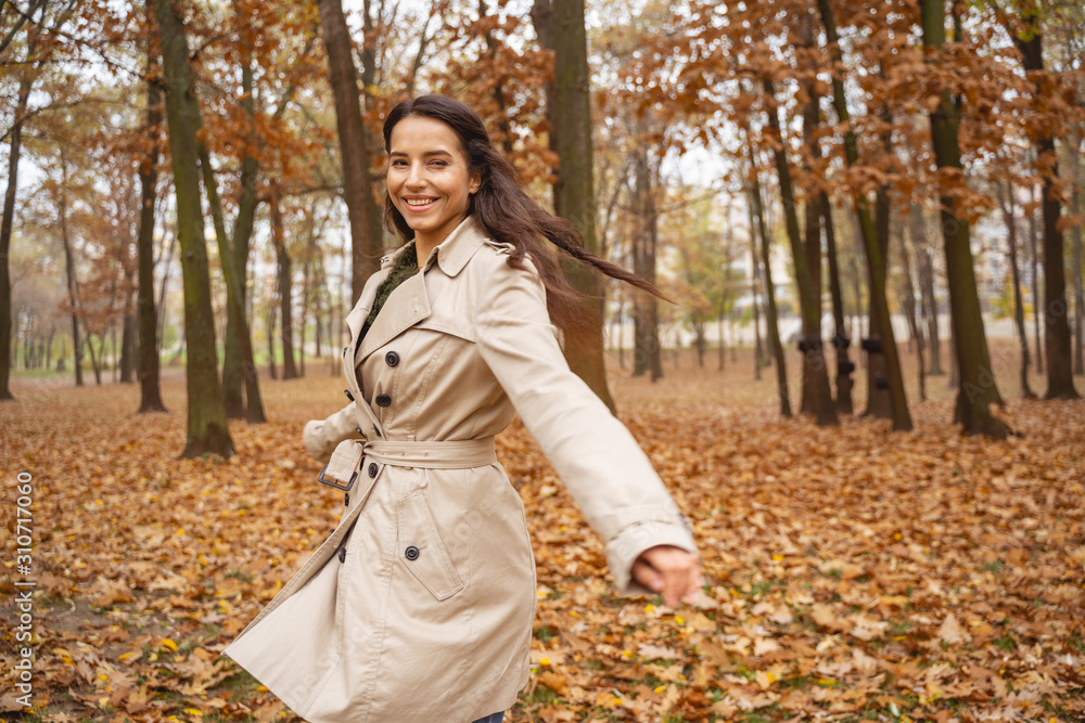 Joyful young woman walking with great pleasure Joyful young woman walking with great pleasure