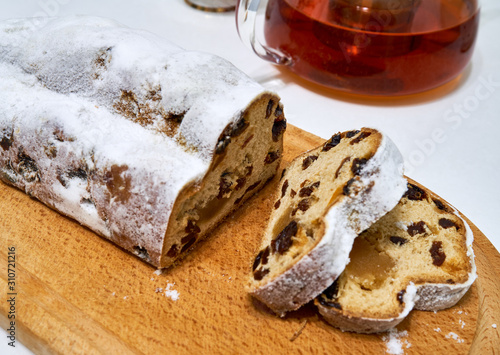pie stollen with tea lies on a wooden board