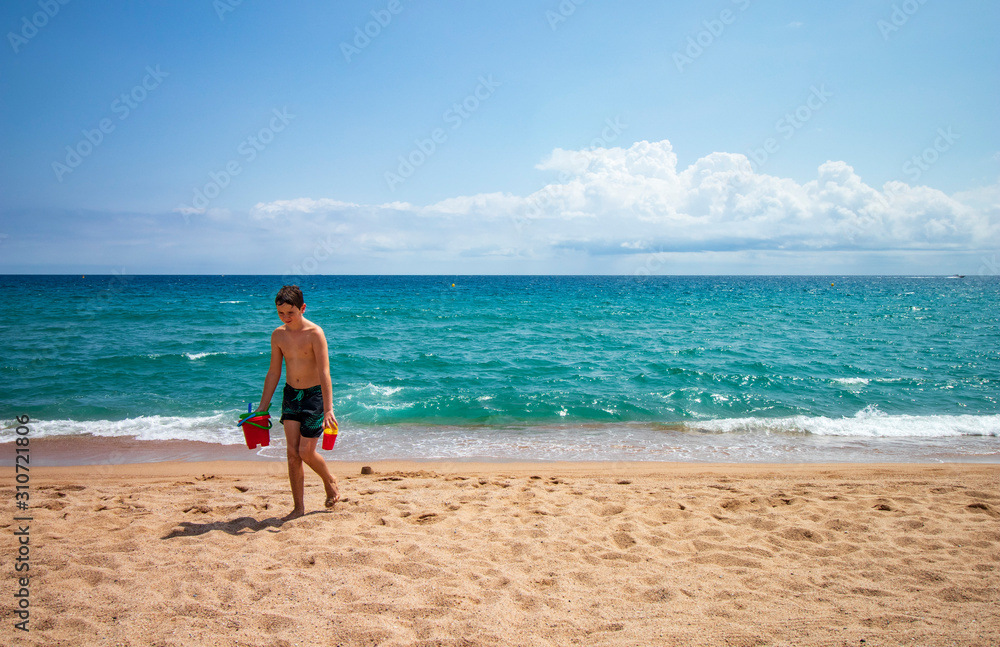 Caucasian boy playing on the beach