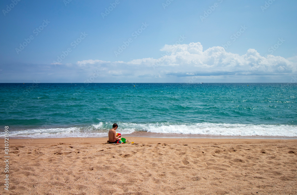 Caucasian boy playing on the beach