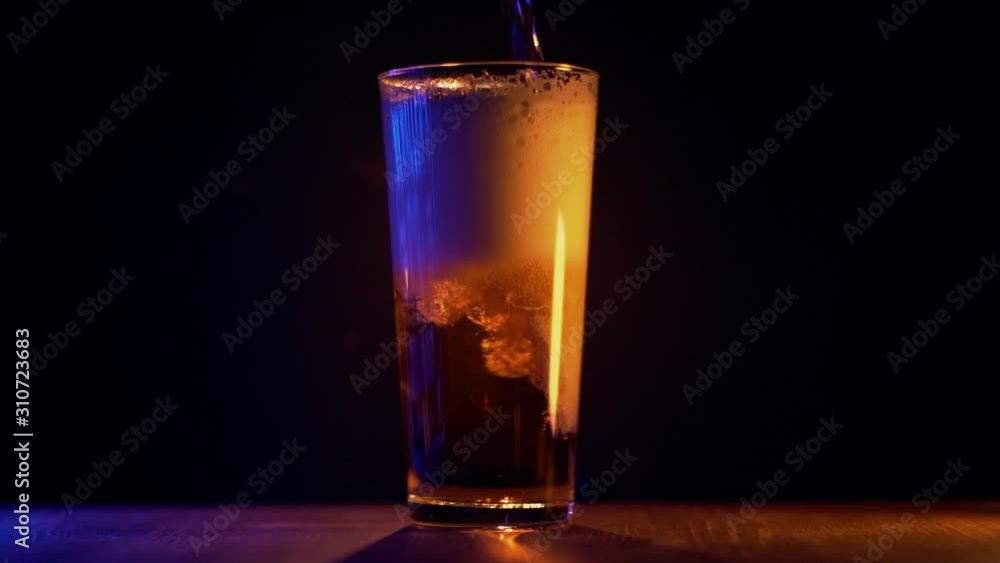 Glass of beer at black background. Slow motion. Beer bubbles slow motion. Close up view. Glass of beer at black background. Slow motion. Beer bubbles slow motion. Close up view.