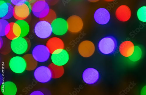 Festive background - multicolored blurry lights. The concept of celebration, new year, event, party. Copyspace. Red, green, purple shades.