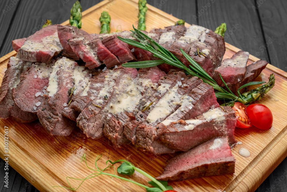 Beef sliced on wooden background