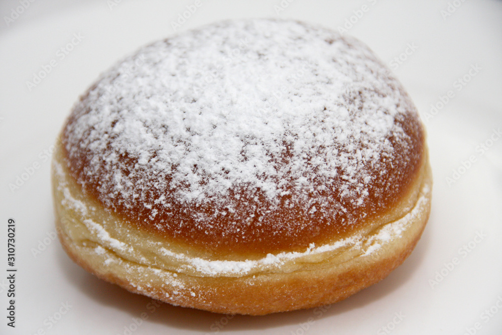 Fresh homemade Austrian Carnival Donut so called Faschingskrapfen or Berliner, sweet Krapfen filled with apricot jam and icing sugar close up on white Background Fresh homemade Austrian Carnival Donut so called Faschingskrapfen or Berliner, sweet Krapfen filled with apricot jam and icing sugar close up on white Background
