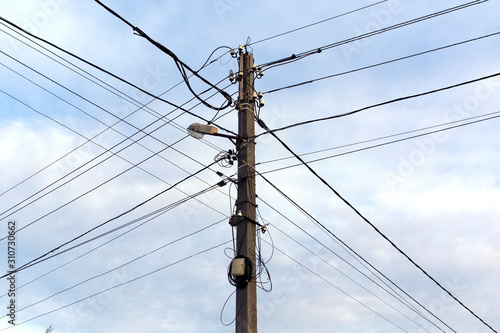 Wallpaper Mural Electric pole with a lantern and electric wires. Light blue sky on background. Torontodigital.ca