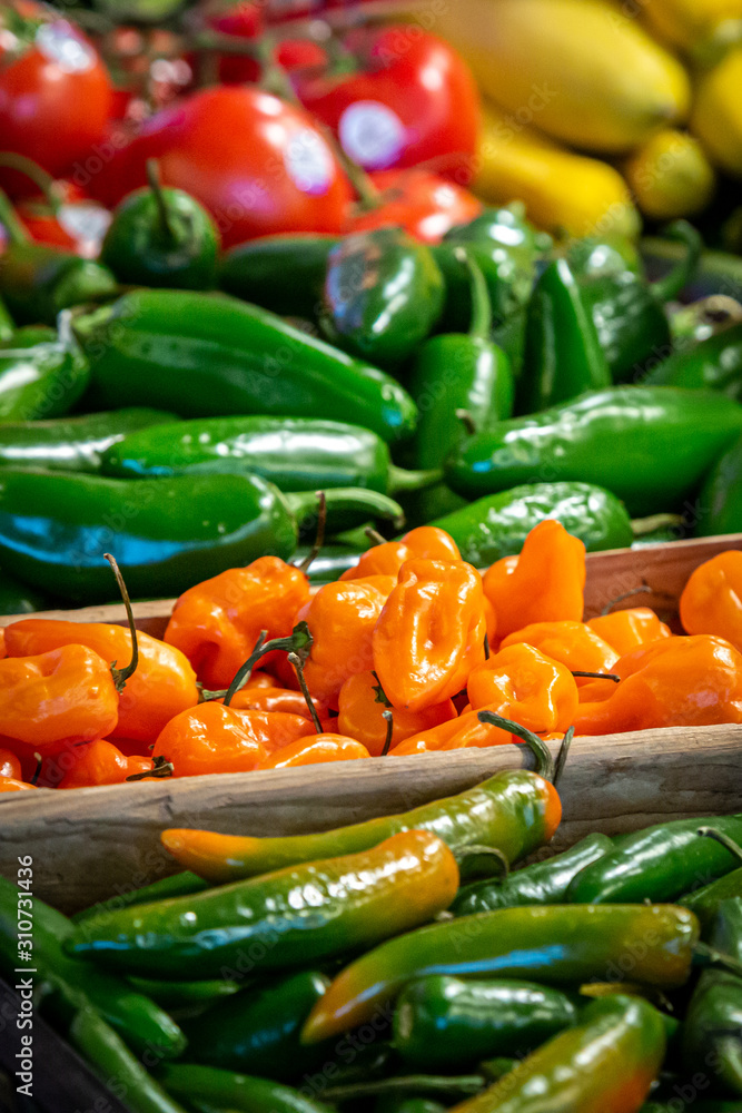 A display of vibrant chillies for sale on a market stall