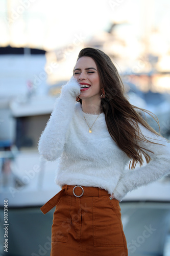 Fashion Model In White Fluffy Knitted Pullover And Brown Miniskirt