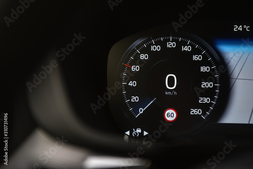Speedometer in black background and traffic sign recognition system.