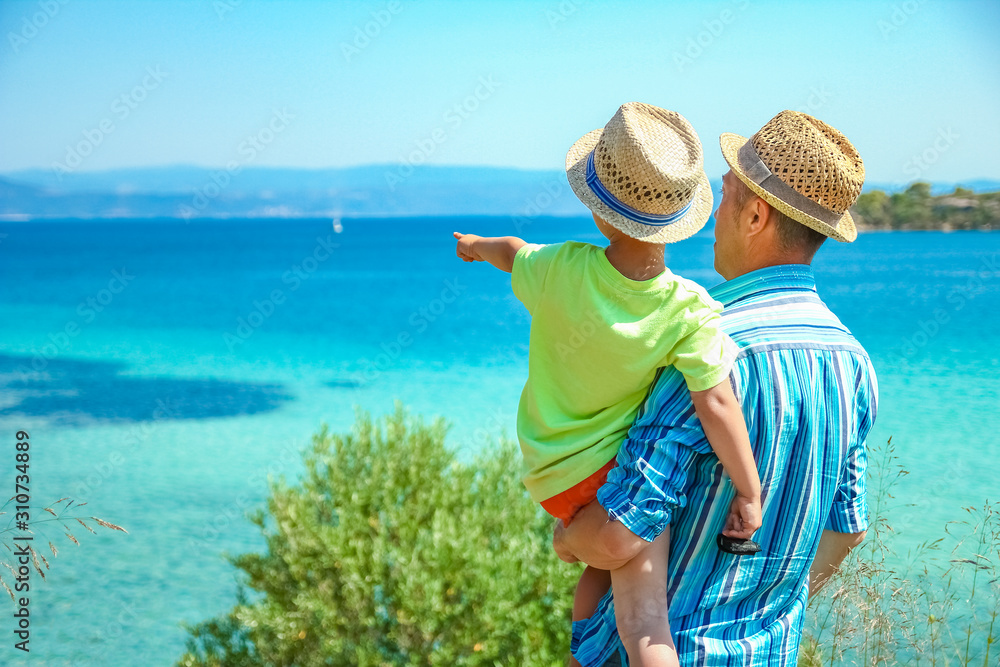 happy parent with child by the sea greece outdoors