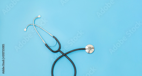 Medicine equipment stethoscope or phonendoscope isolated on trendy pastel blue background. Instrument device for doctor. Health care life insurance concept Banner