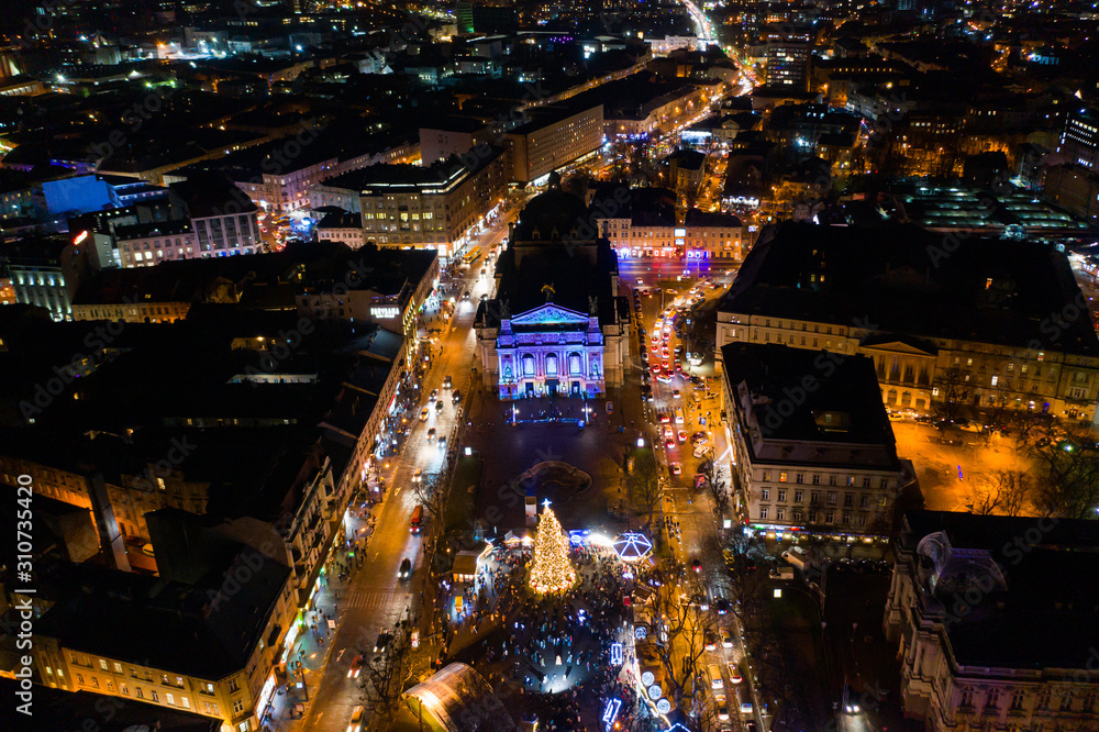Opening of Christmas tree near Opera House in Lviv, Ukraine. View from drone - obrazy, fototapety, plakaty 