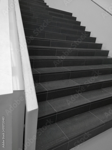 Low angle close-up photo of staircase in perspective. Abstract modern architecture or interior background in concept of rise, ascent or moving up.