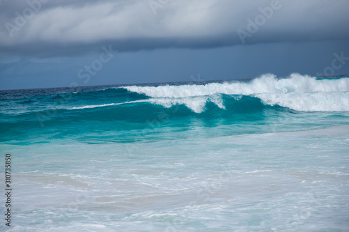 Turquoise ocean waves with dramatic sky