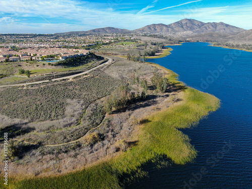 Aerial view of Otay Lake Reservoir with blue sky and mountain on the background, Chula Vista, California. USA