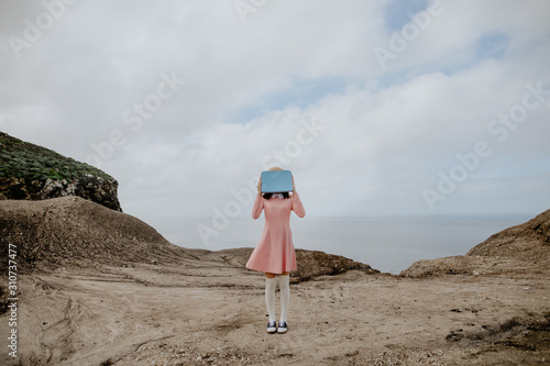 Faceless girl in dirt photo