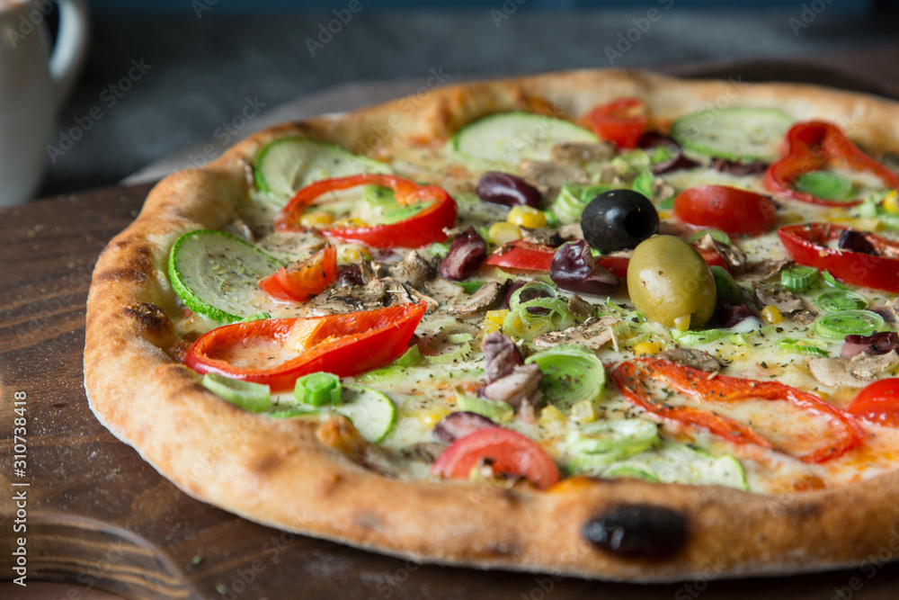 Italian pizza with red peppers, corn and cucumber Italian pizza with red peppers, corn and cucumber