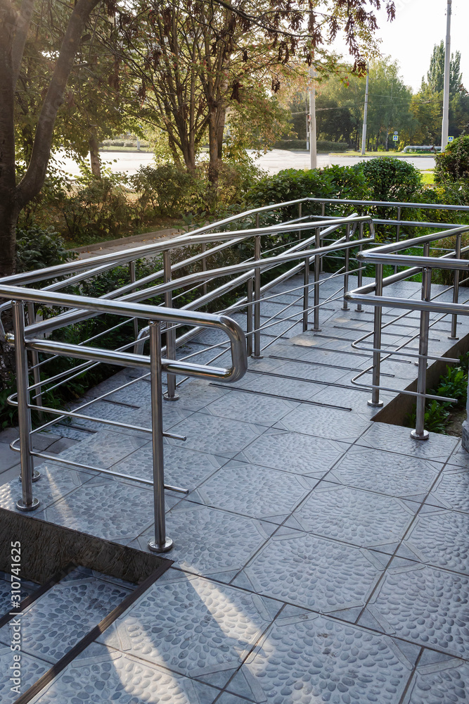 entrance to city store with special ramp for support disabled people using wheelchair entrance to city store with special ramp for support disabled people using wheelchair