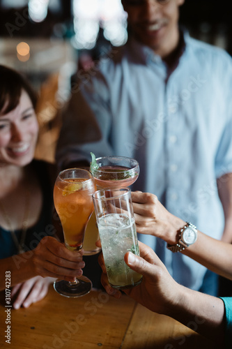 Friends toasting at happy hour