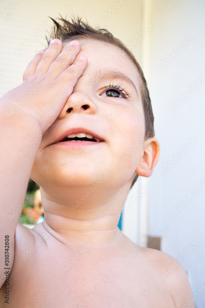 Child covering his eye Child covering his eye