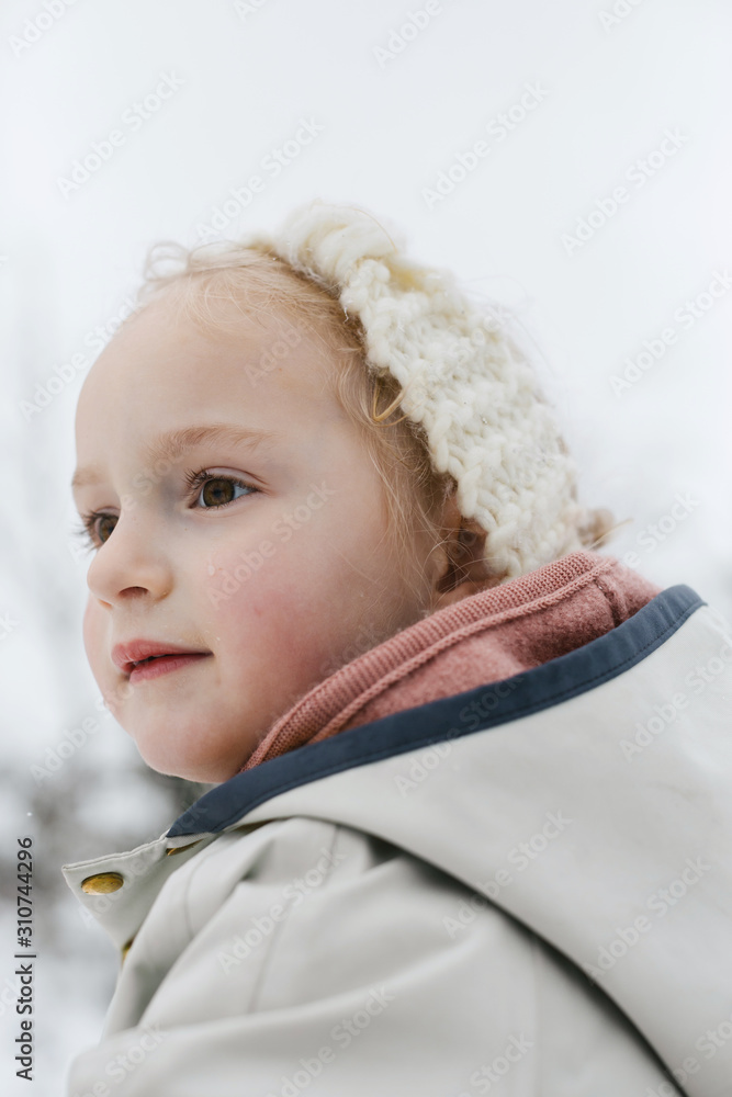 Cute little girl exploring nature in the snow Cute little girl exploring nature in the snow