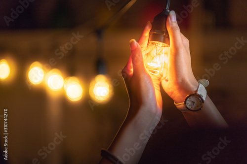 Girl holding a lightbulb