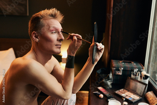Masculine Guy Doing Makeup photo