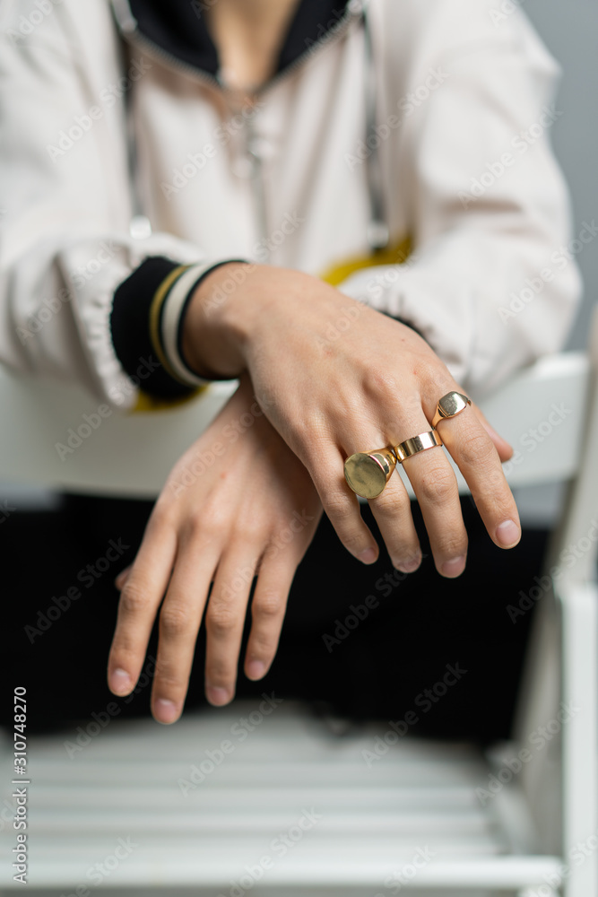 Crop female model with golden rings Crop female model with golden rings