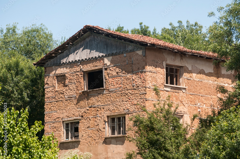 Old rural house with adobe clay walls in sunny summer day Old rural house with adobe clay walls in sunny summer day