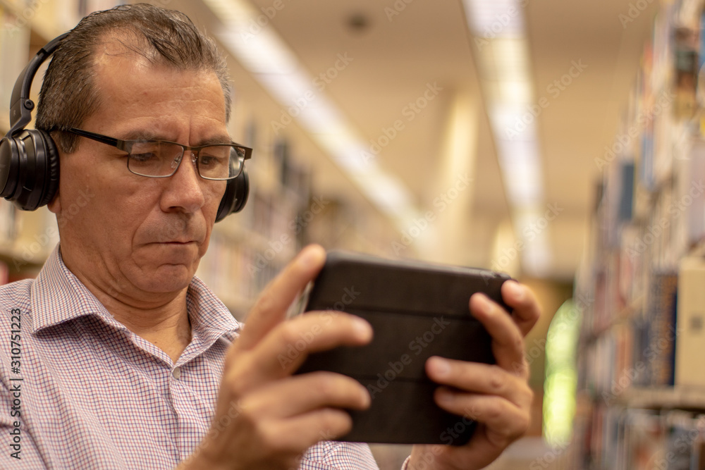 man reading in library man reading in library
