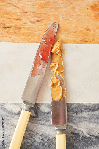 Knives Making Peanut Butter and Jam Sandwiches photo