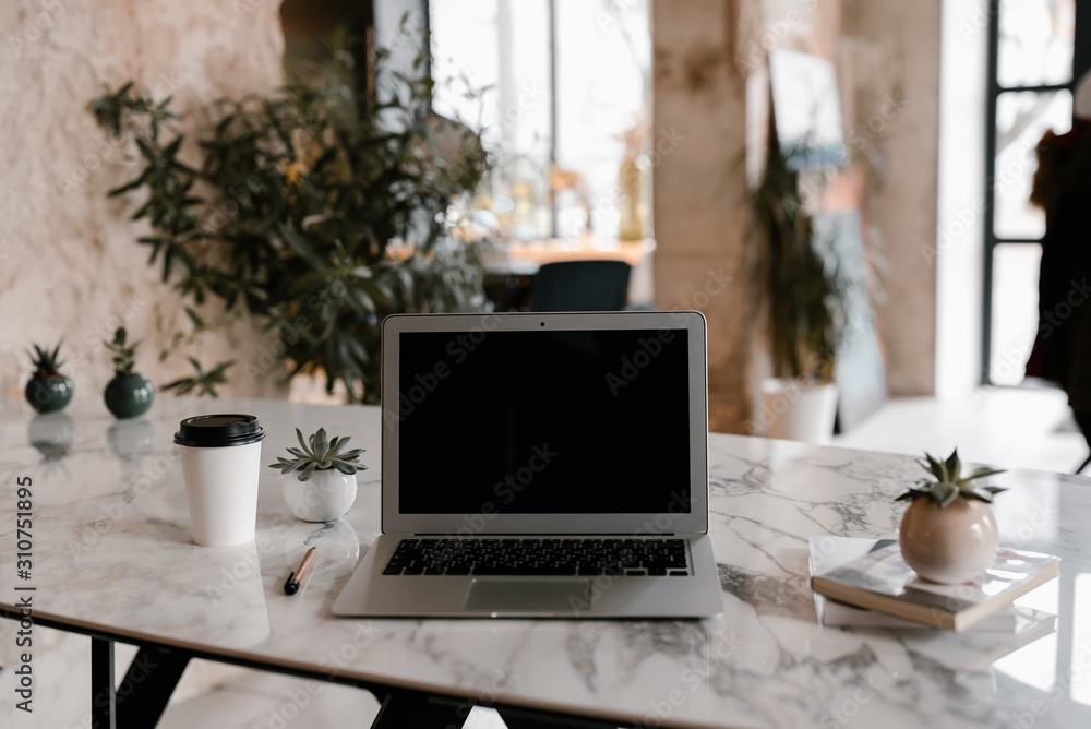Laptop on table in stylish room Laptop on table in stylish room