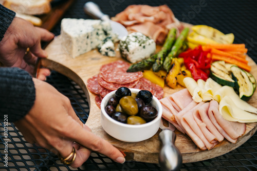 Woman placing crudites on a patio table