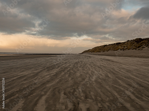 Norderney  Germany. 7 December 2019. Sandy beach on the North Sea coast on a windy winter afternoon in warm light.