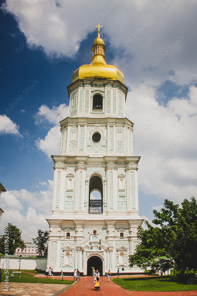 Bell tower of St. Michael monastery. Big white tower with blue intarsions and golden dome on top.