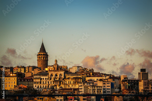 Evening view towards Beyoglu and Karakoy in the city of Istanbul over the sea just next to the Galata brdge. Famous Galata tower or Galata Kulesi is rising above the skyline.