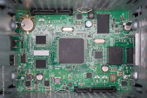 Electronic components on a green motherboard photo