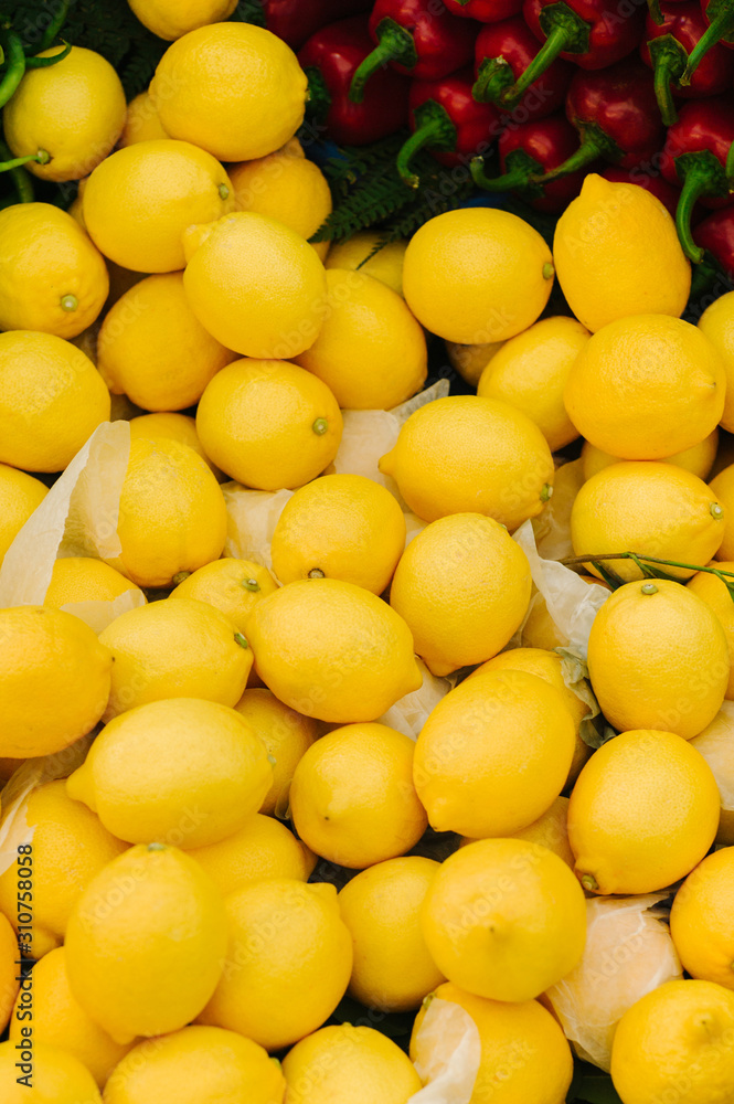 Tasty yellow lemons near peppers selling in shop Tasty yellow lemons near peppers selling in shop