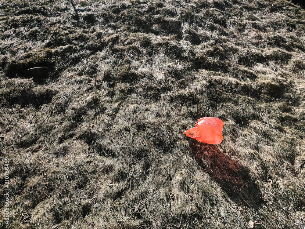 Single Orange Plastic Bag Trash in Winter Landscape Single Orange Plastic Bag Trash in Winter Landscape