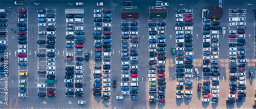 Bird's eye aerial view from drone parking lot with colored cars on a gray asphalt background. Top view strictly above. photo