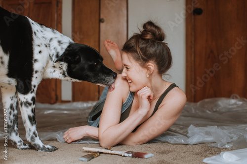 Dog Licking Happy Woman's Shoulder photo