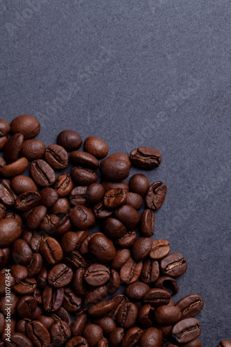 Roasted coffee beans on granite background