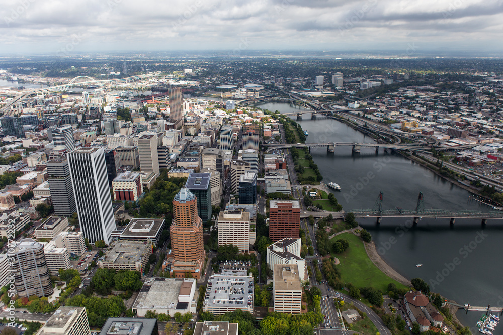 Aerial cityscape view of the Williamette River, buildings, bridges and streets in downtown Portland, Oregon, USA.