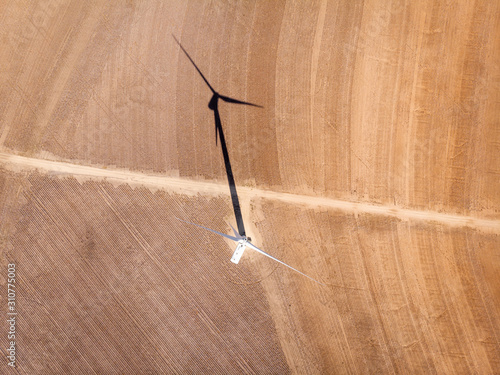 Wind turbines aerial shot with shadow crossing road