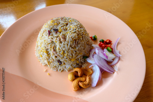 Obraz na płótnie Salted chinese black olive fried rice with minced pork In a light red dish on an orange wooden table Is a popular Asian food in Thailand. w salonie