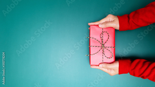 Happy Boxing Day, young woman hand with a gift box offer to receiver