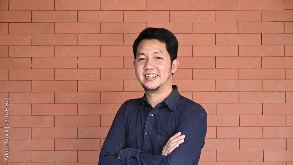 4K Portrait of happy asian man looking at camera and smiling. Hapiness portrait concept. Confident man portrait slow motion. 4K Portrait of happy asian man looking at camera and smiling. Hapiness portrait concept. Confident man portrait slow motion.