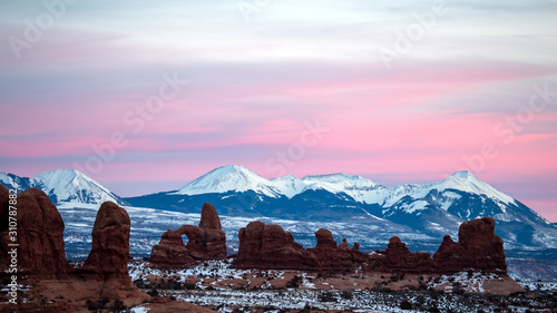 Sunset over Turret Arch looking towards the La Sal Mountains in Arches National Park in Winter.